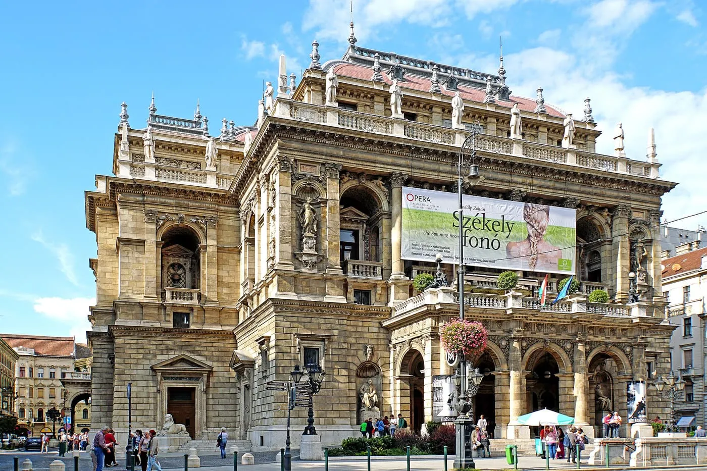 The stone Neo-Renaissance front of the Hungarian State Opera House, with statues along its roofline and loggias above the entrance