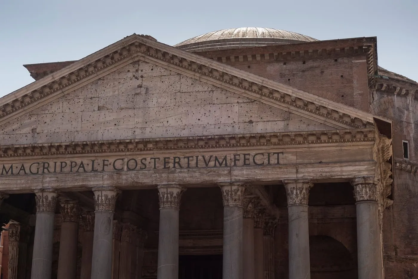The Pantheon's pediment and the inscription of Agrippa above the granite columns of the portico, with the dome behind