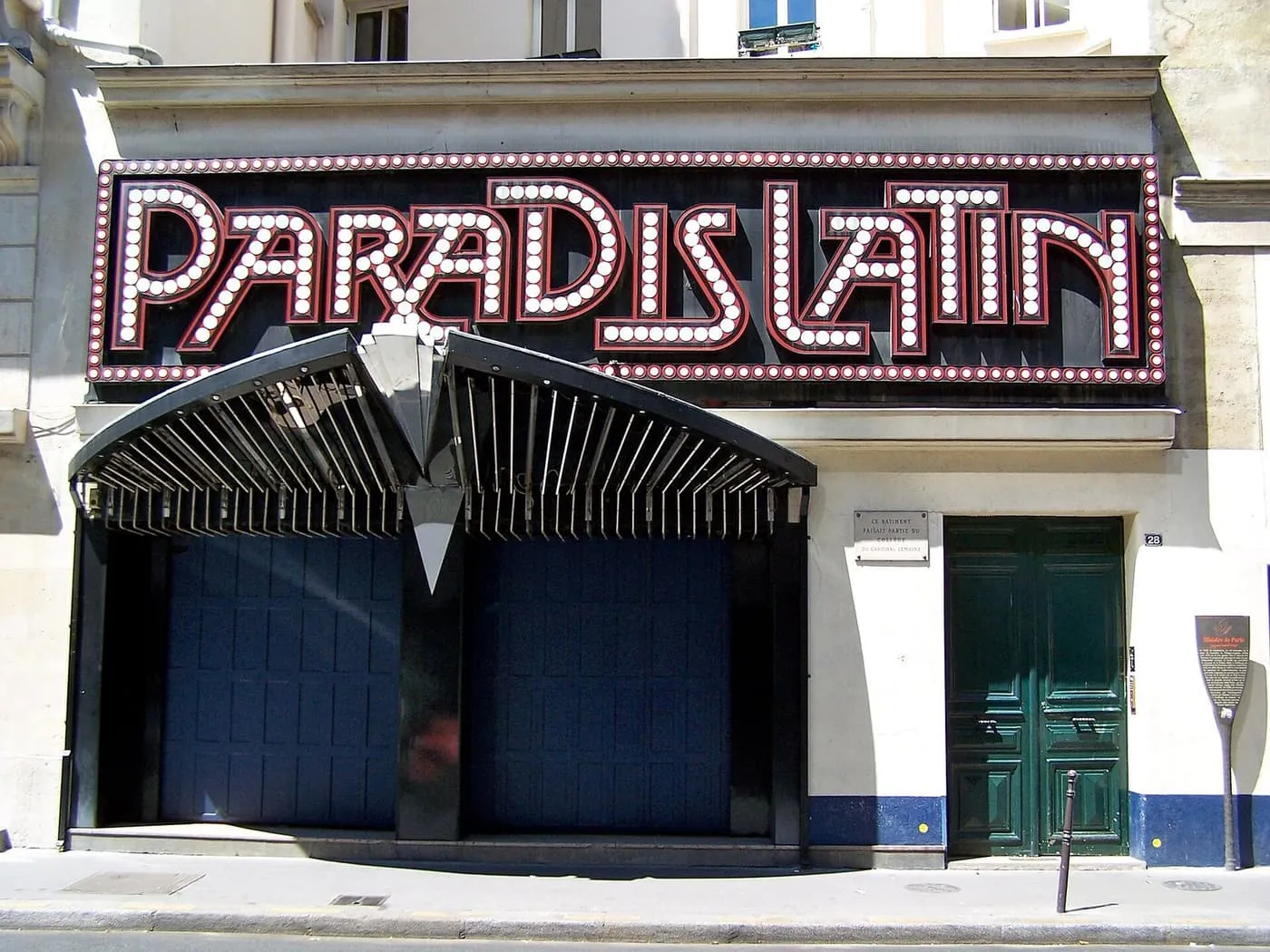 The daytime frontage of the Paradis Latin cabaret on rue du Cardinal Lemoine, with its bulb-lit sign above the entrance canopy