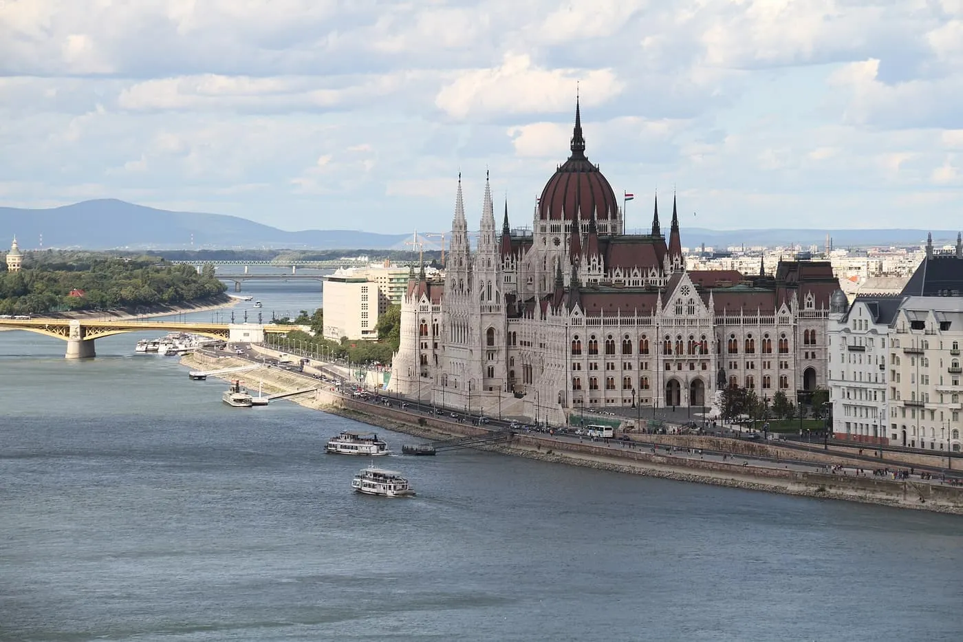 The Hungarian Parliament Building beside the Danube, with Margaret Bridge to the left and river boats in front