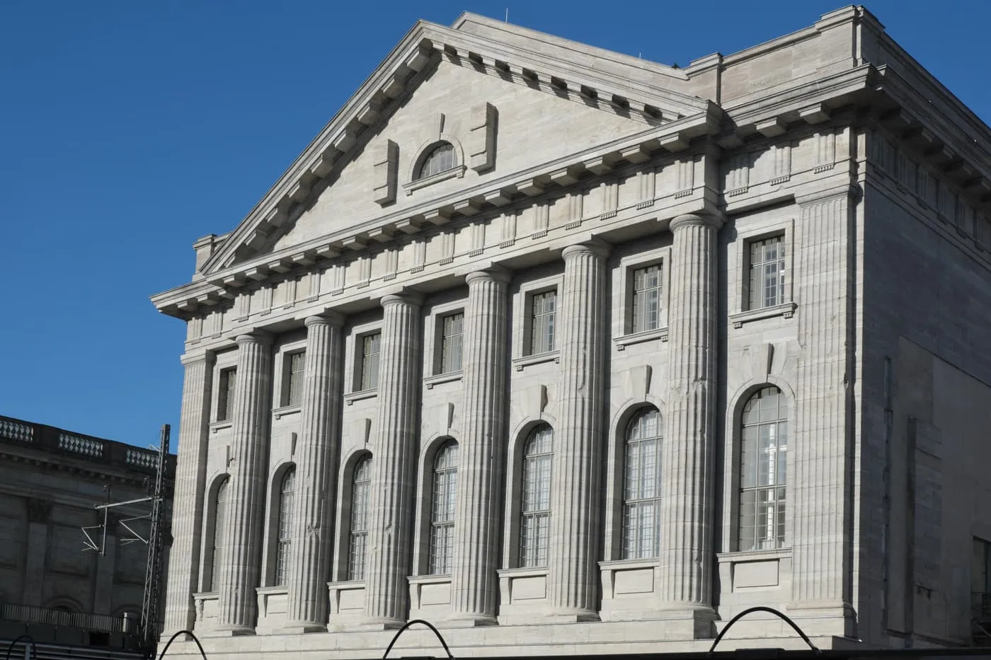 The stone front of the Pergamonmuseum, with a pediment above a row of tall fluted columns and arched windows
