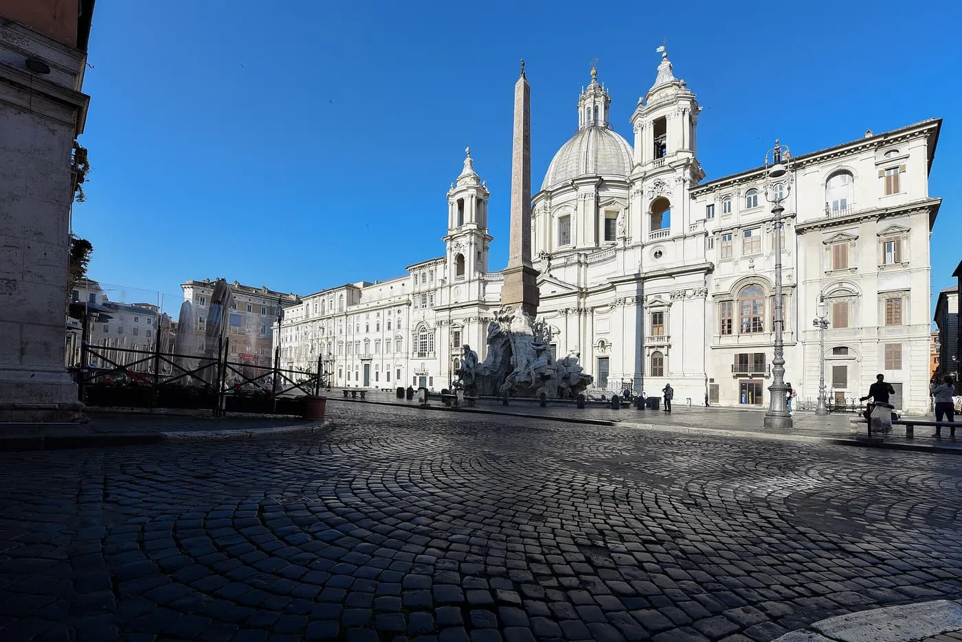 Piazza Navona on an empty morning, with the Fountain of the Four Rivers and its obelisk in front of the domed church of Sant'Agnese in Agone