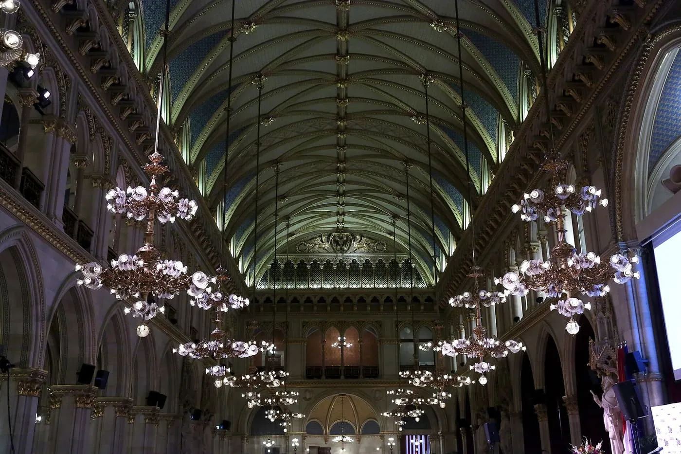 The vaulted Gothic ceiling of the Rathaus Festsaal with rows of hanging chandeliers
