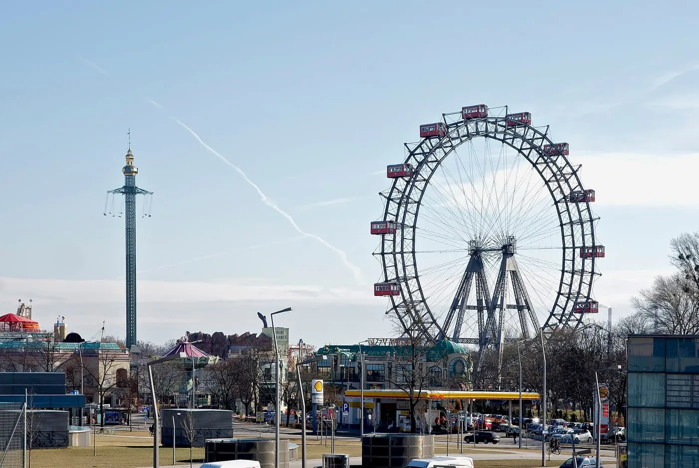 The Riesenrad, a giant Ferris wheel with red cabins, beside the tall Prater Tower swing ride
