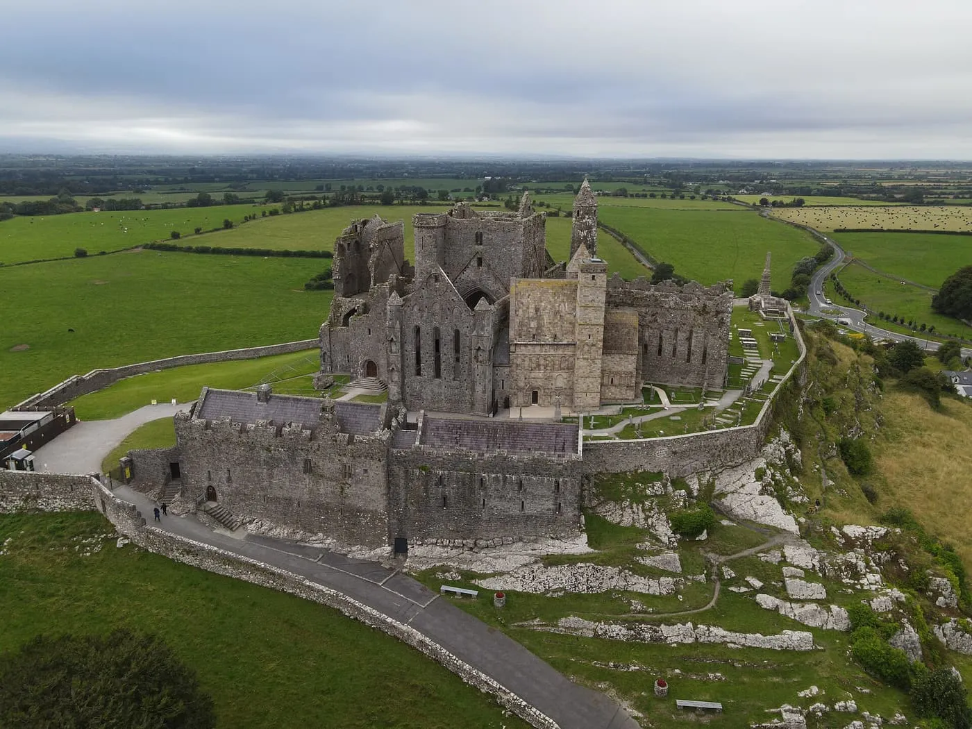 The Rock of Cashel from the air, the cathedral, round tower and castle on a limestone outcrop above flat green fields