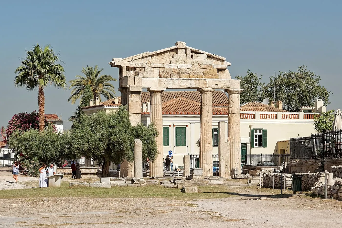 The gate of Athena Archegetis, Doric columns carrying a stone pediment, with palms and an olive tree in front