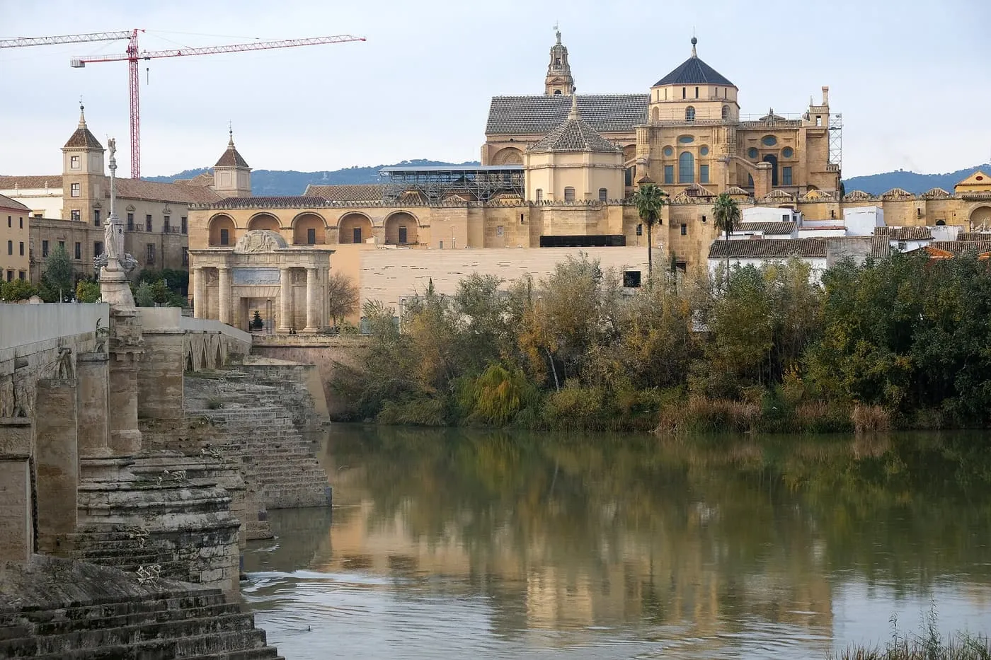 The Roman bridge across the Guadalquivir in Córdoba, with the Puerta del Puente gate and the Mezquita-Catedral rising behind it