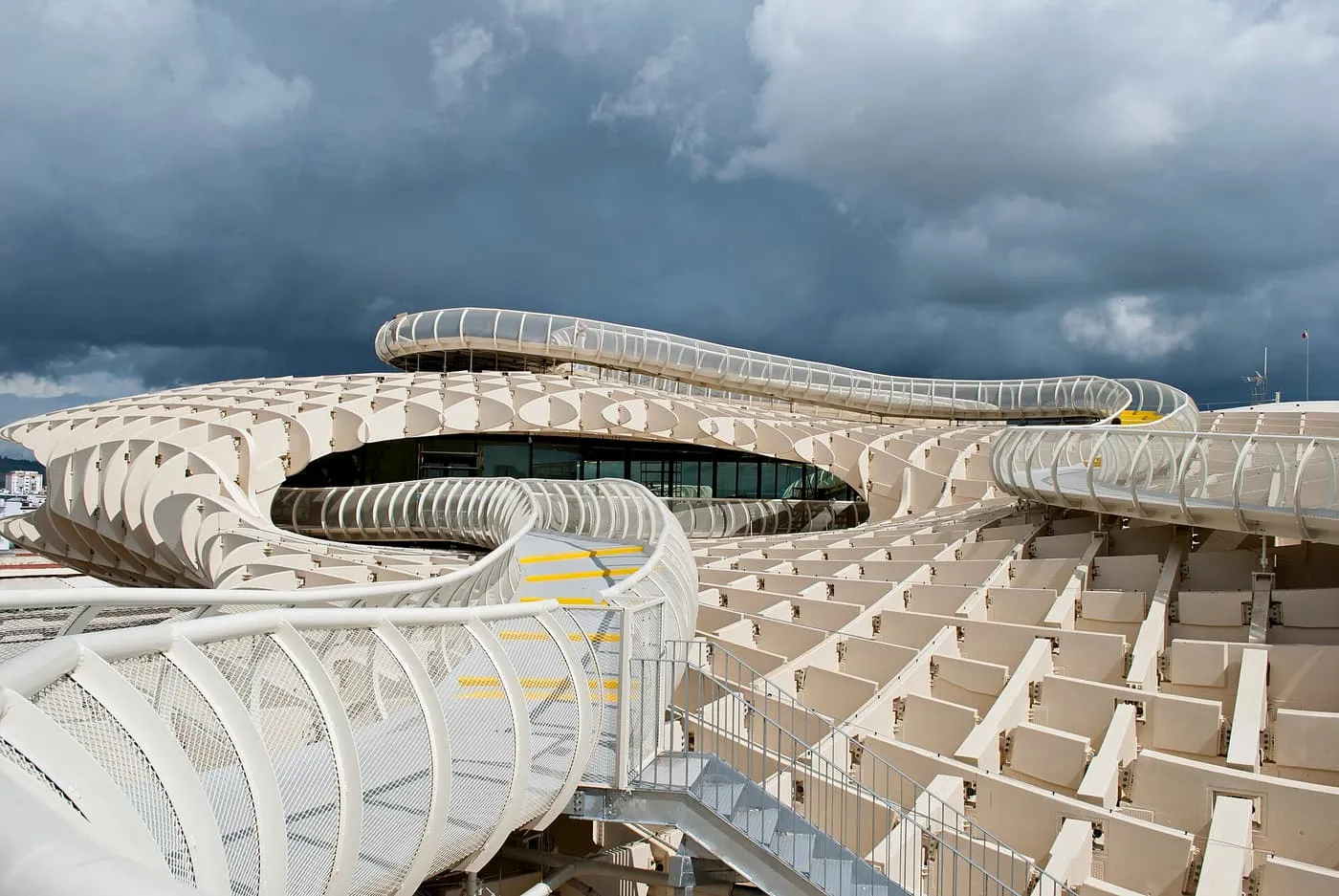The white walkway winding over the roof of the Metropol Parasol under a stormy sky