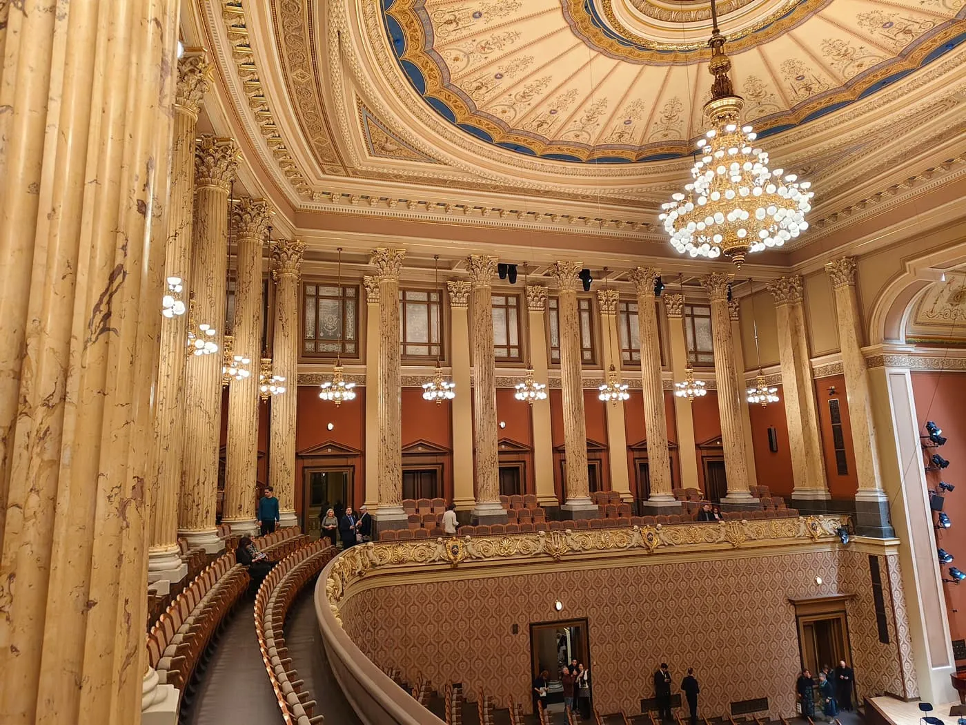 The Dvořák Hall in the Rudolfinum seen from the balcony, with marble columns, chandeliers and a coffered dome