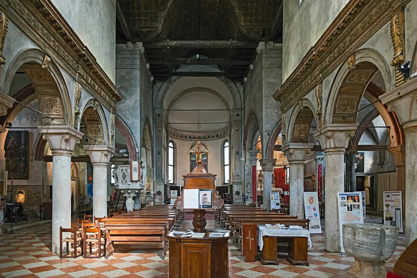 The nave of San Giacomo dall'Orio, with marble columns and a timber roof