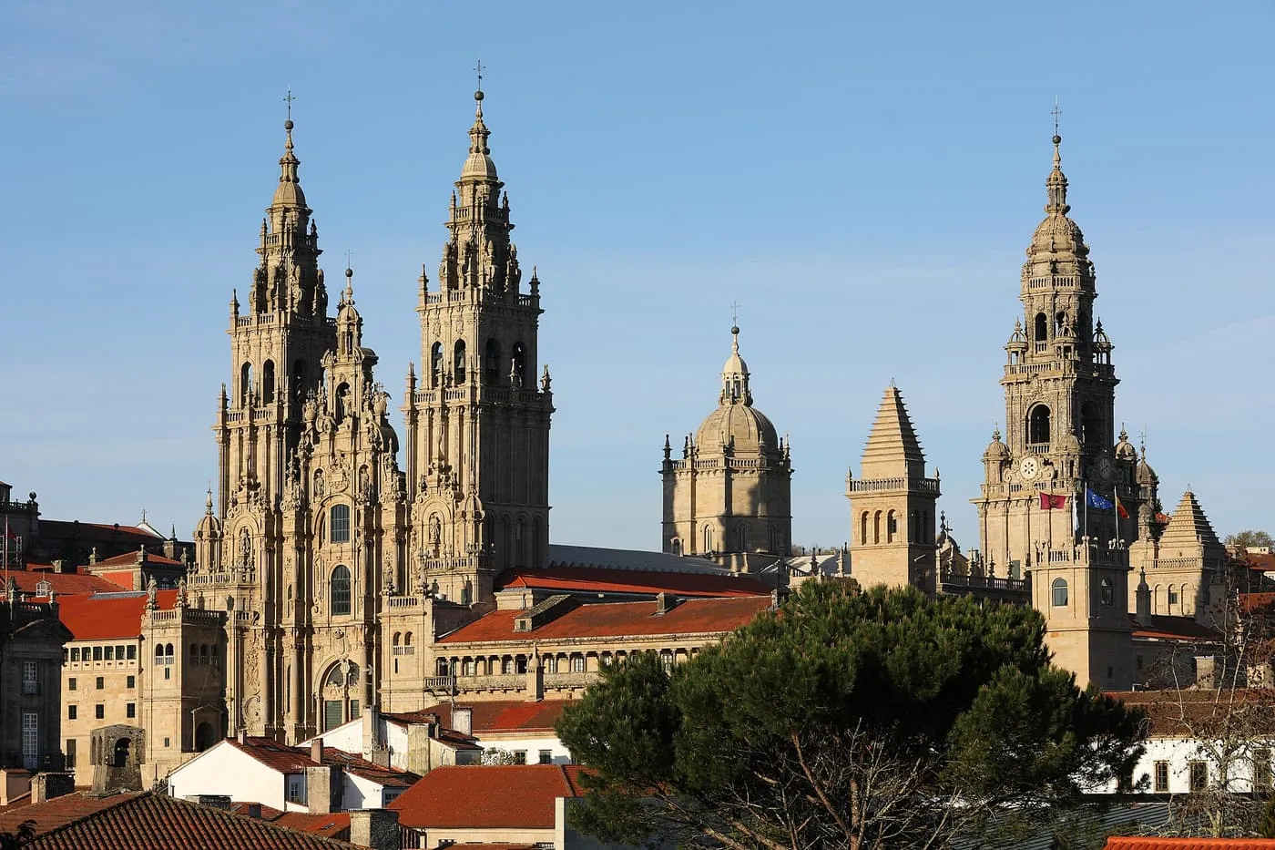 The twin baroque towers and other spires of Santiago de Compostela Cathedral rising above red-tiled roofs