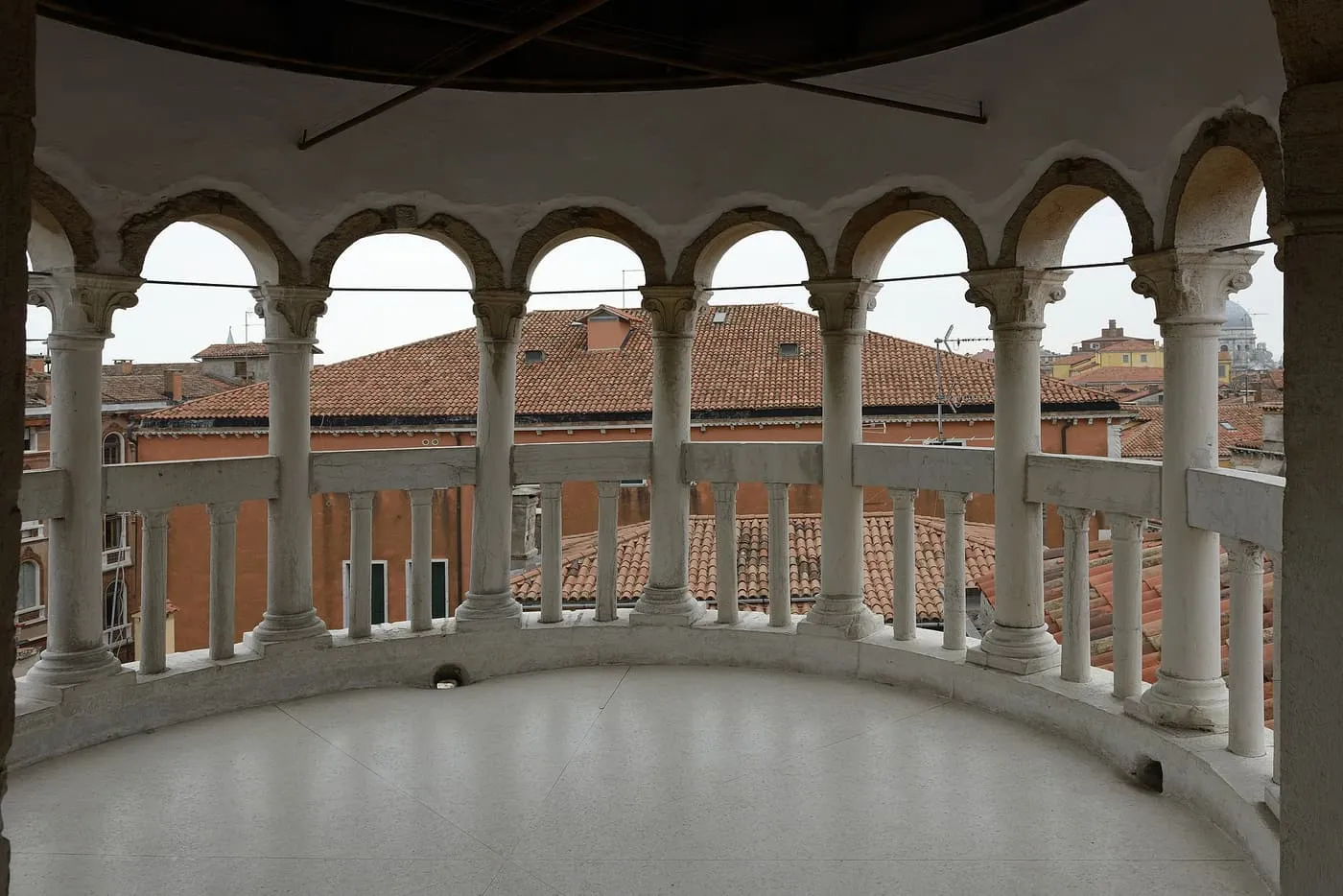 The open loggias at the top of the Scala Contarini del Bovolo, looking out over terracotta roofs