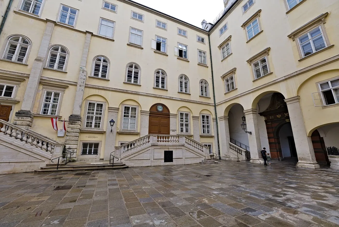 The Schweizerhof, a Hofburg courtyard with pale yellow façades, double stone stairs and arched doorways