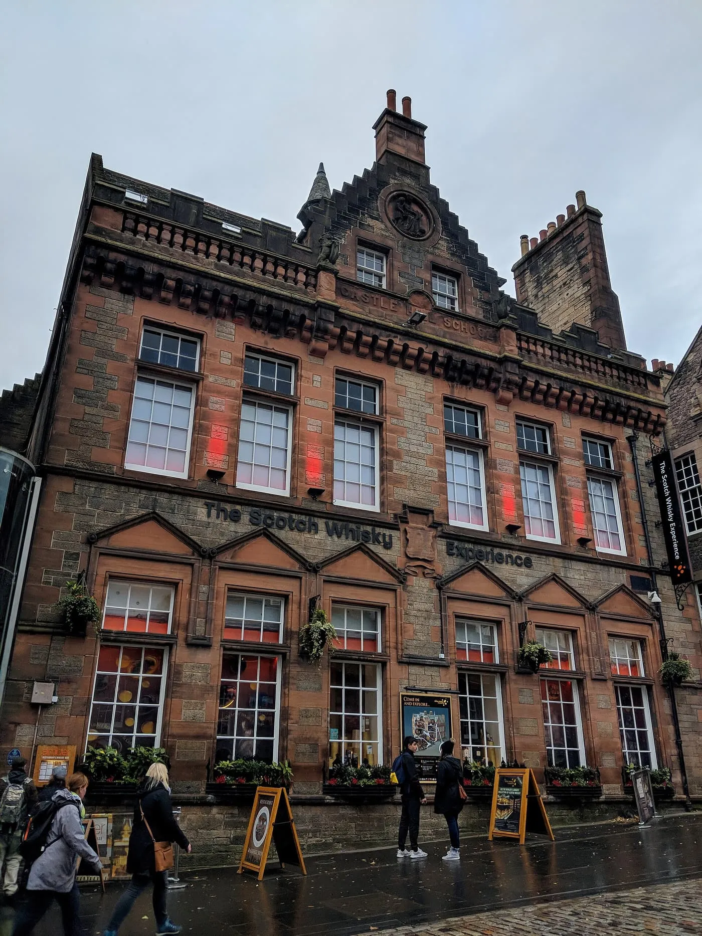 The red sandstone former Castlehill School, now the Scotch Whisky Experience, with its name across the front