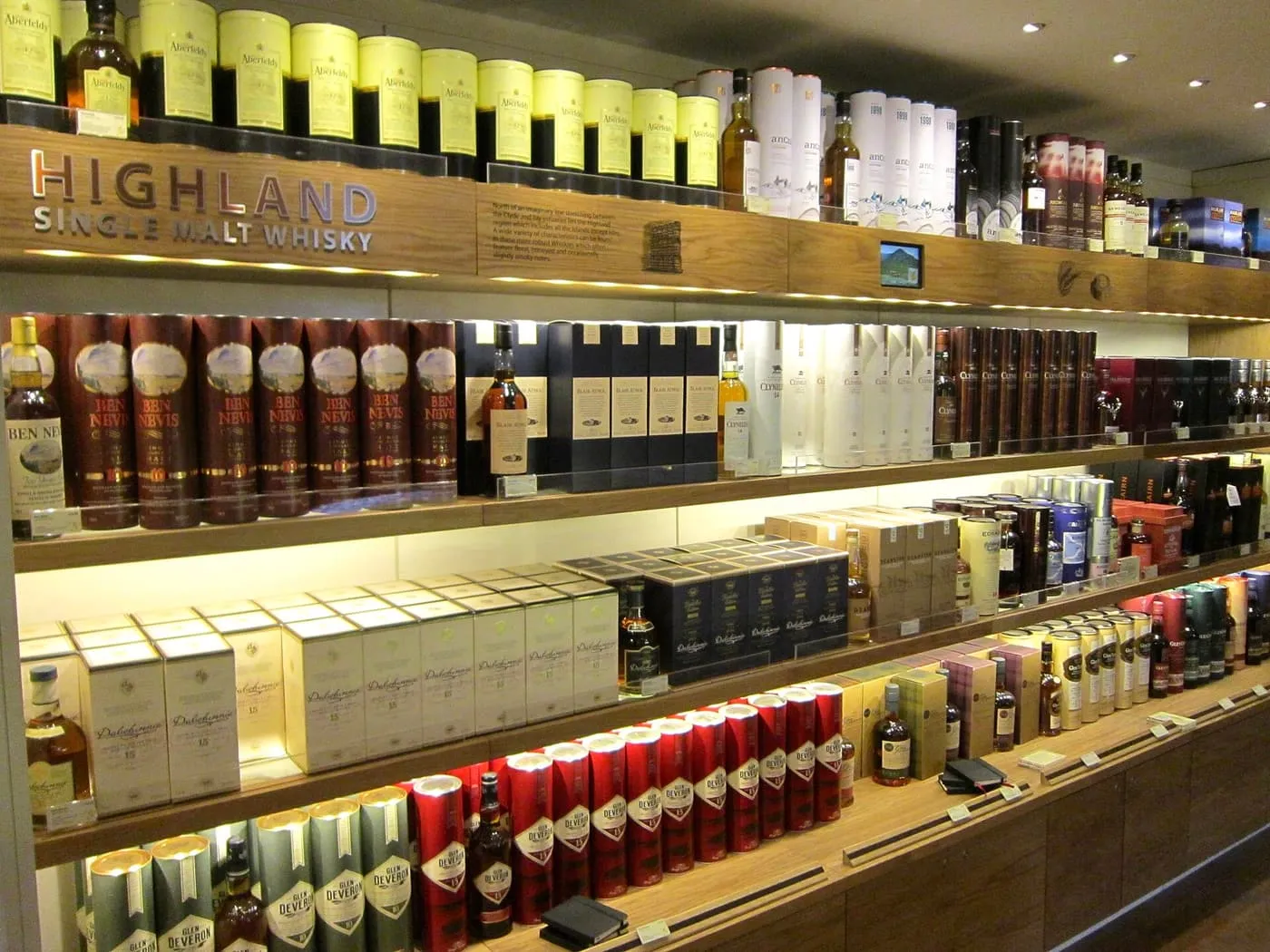 Shelves of Highland single malt whisky in presentation tubes and boxes at the Scotch Whisky Experience