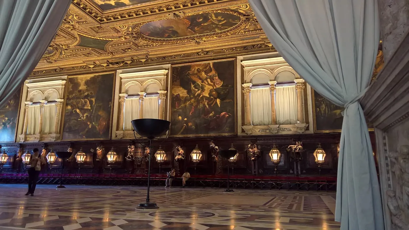 The upper hall of the Scuola Grande di San Rocco, with Tintoretto's paintings above a carved bench