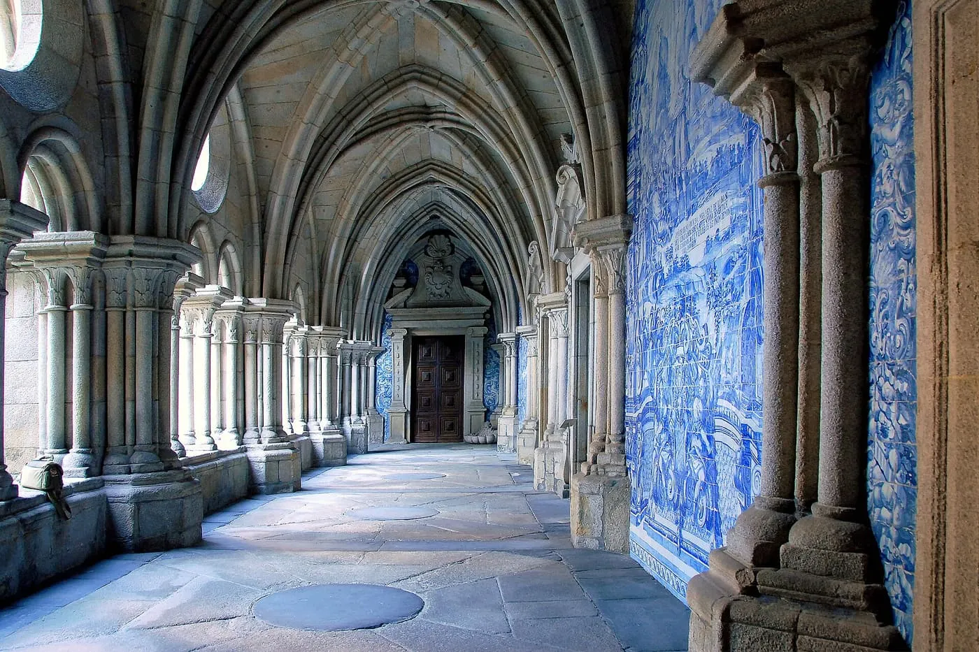 A Gothic cloister gallery of the Sé do Porto, its walls lined with blue-and-white azulejo panels