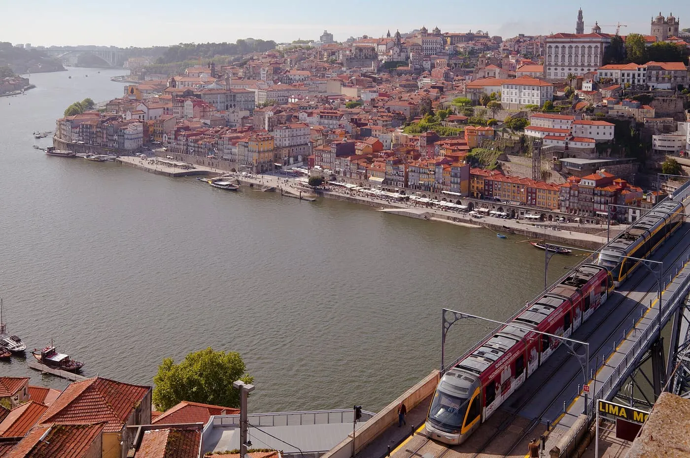 The Ribeira and the Dom Luís I bridge seen across the Douro from the Serra do Pilar, with a Metro train on the upper deck