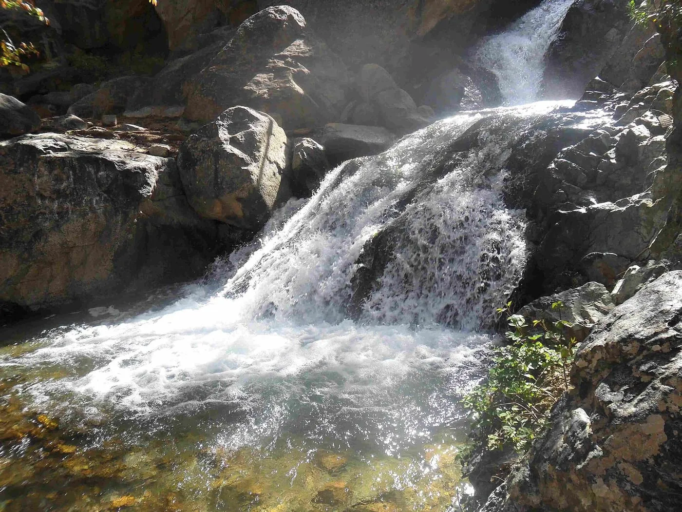 A cascade tumbling over rocks into a clear pool in the Ourika river at Setti Fatma