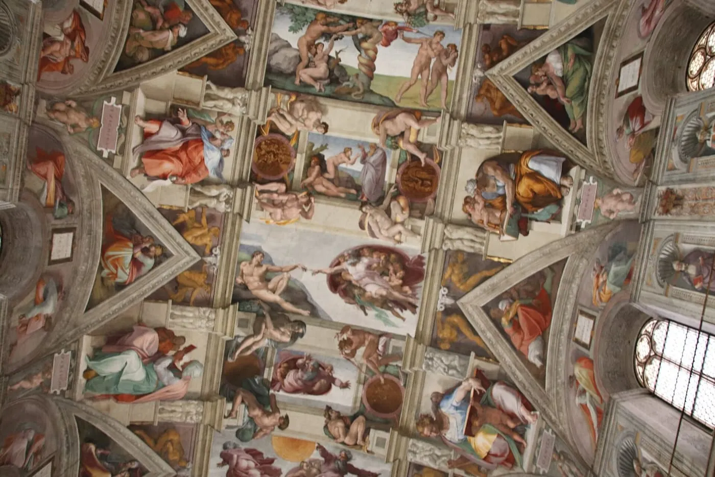 Michelangelo's frescoes on the ceiling of the Sistine Chapel, with the Creation of Adam at the centre