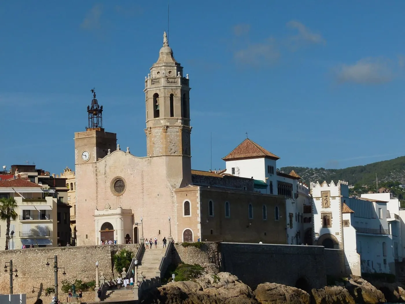 The church of Sant Bartomeu i Santa Tecla on its rocky headland above the sea wall in Sitges