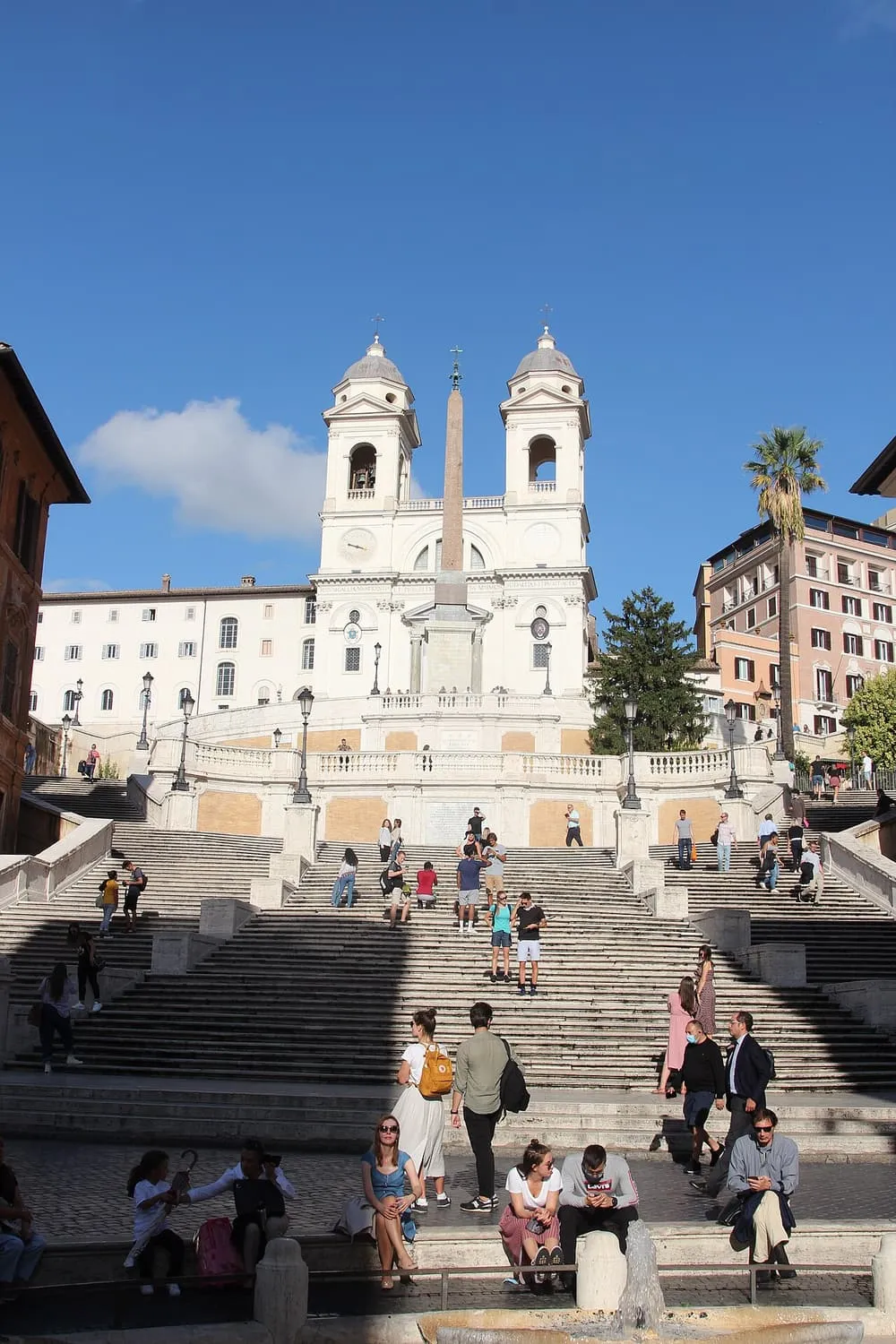 The Spanish Steps rising to the twin-towered church of Trinità dei Monti, with an obelisk in front of it and the Barcaccia fountain at the bottom of the frame