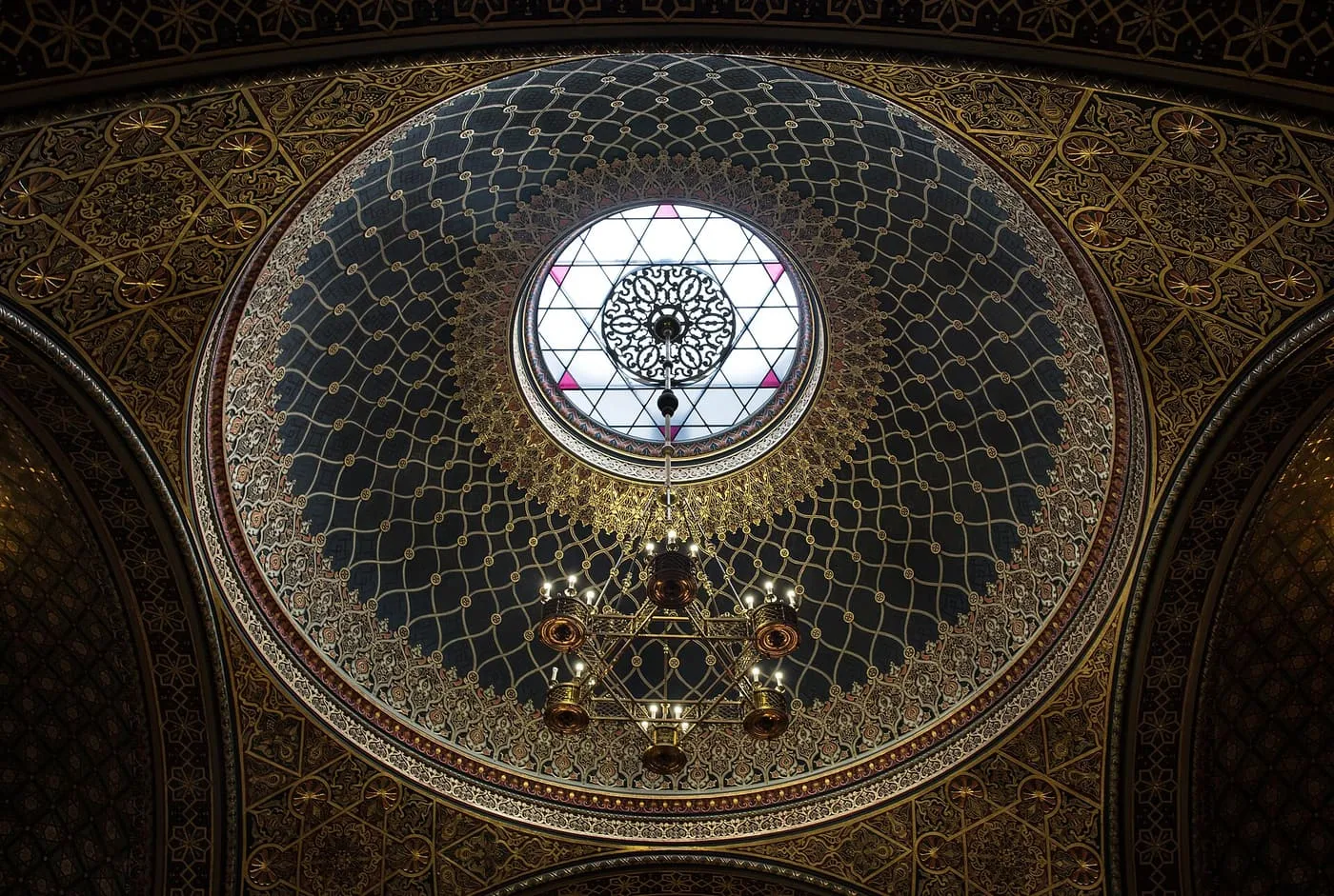 The gilded Moorish-style dome of the Spanish Synagogue, with a Star of David window and chandelier