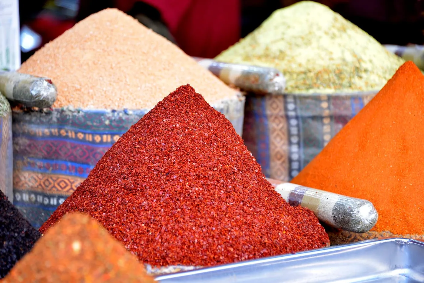 Mounds of red, orange and pale ground spices on a stall in the Spice Bazaar
