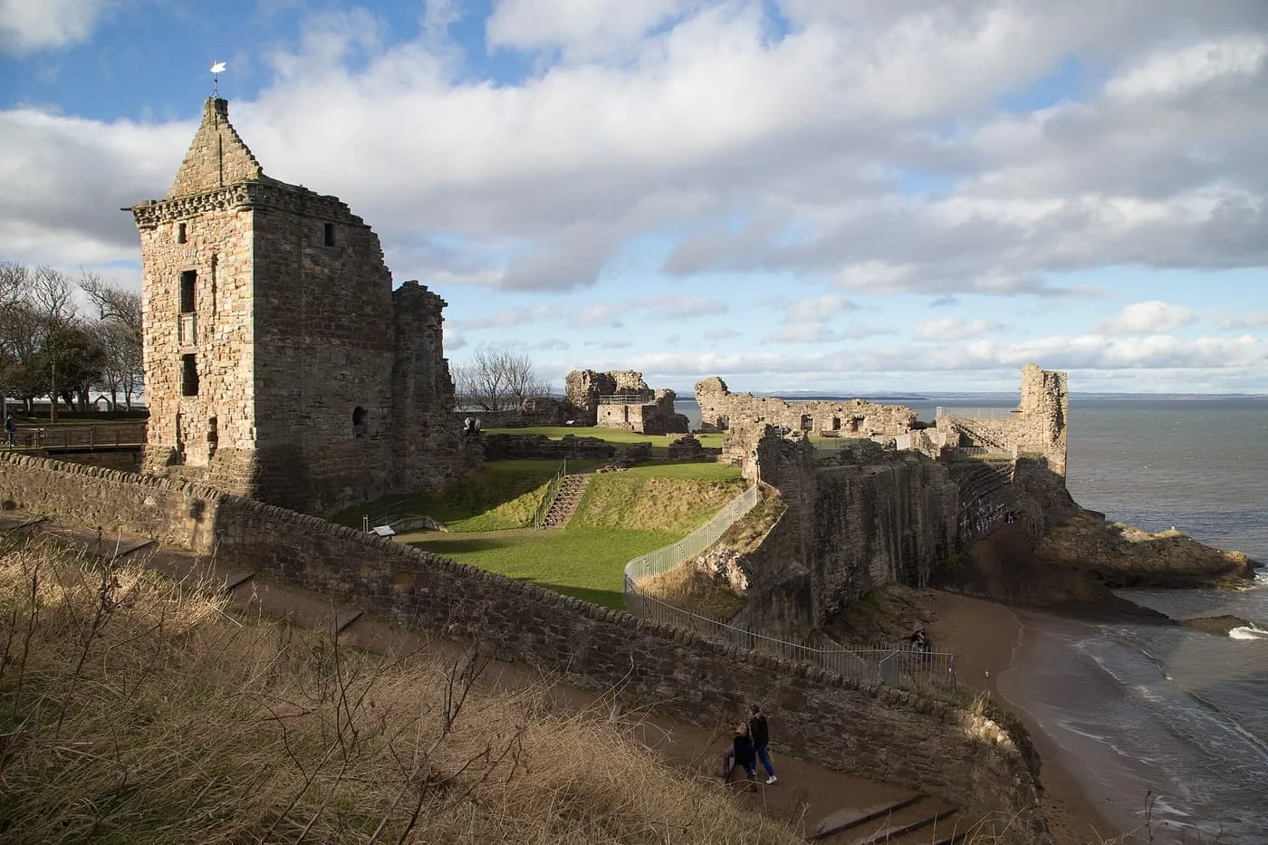 The ruined tower and walls of St Andrews Castle on the shore, with the sea beyond