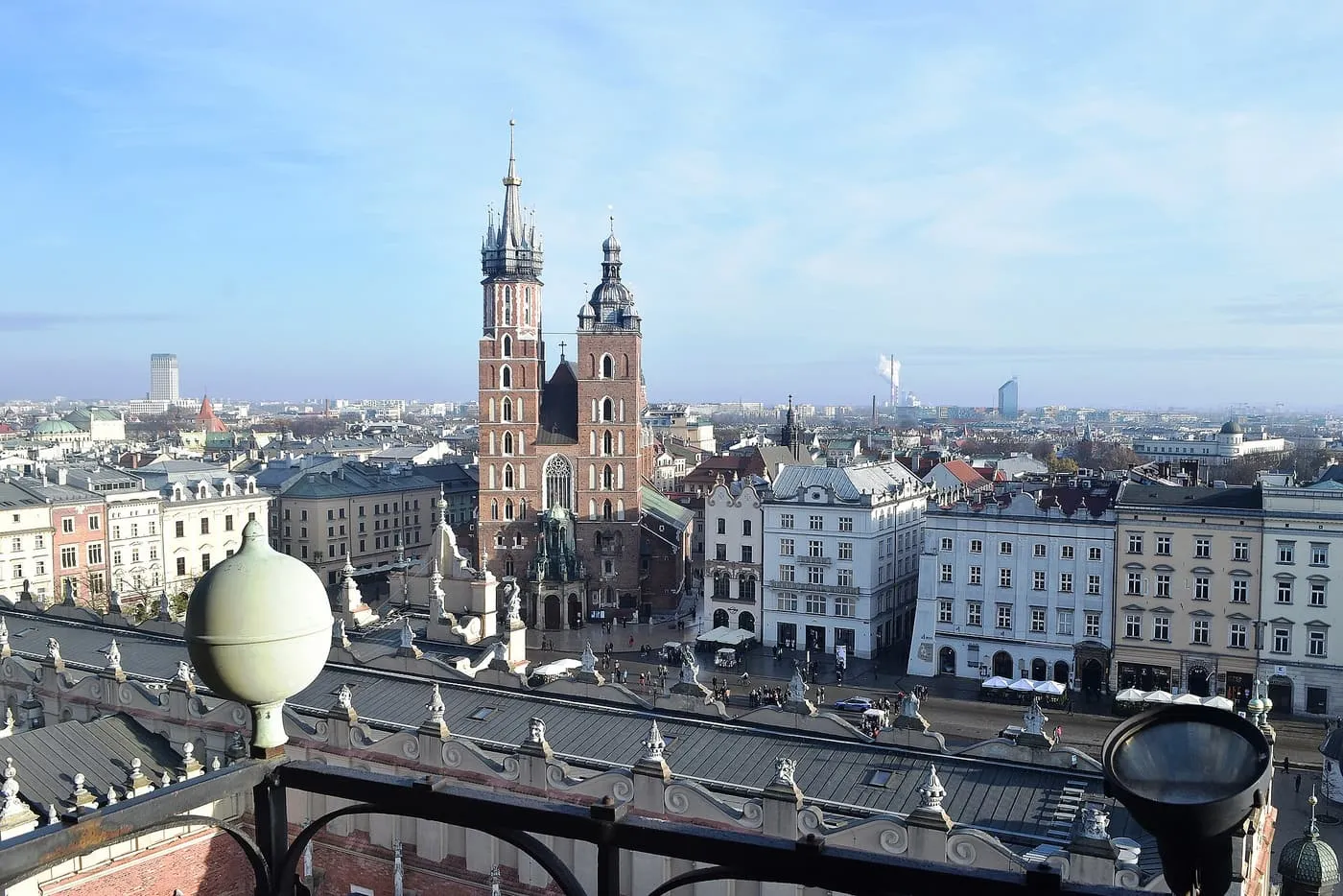 The two towers of St Mary's Basilica rising over the roofs of the Old Town, beyond the decorated attic of the Cloth Hall