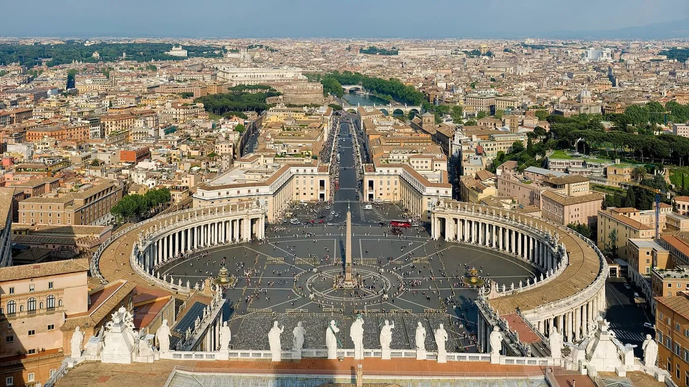 St Peter's Square seen from above, with Bernini's colonnades curving round the obelisk and Via della Conciliazione beyond