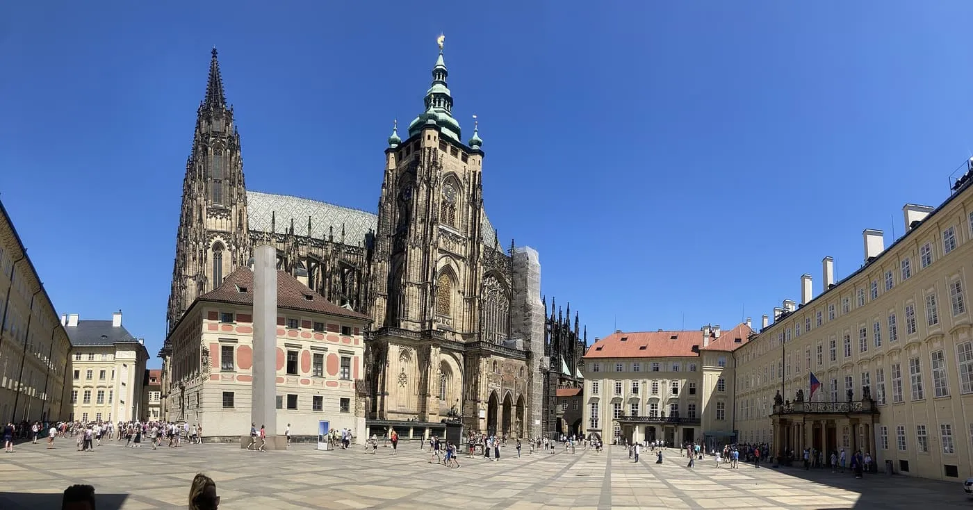 St Vitus Cathedral's spires above the Third Courtyard of Prague Castle, with a granite obelisk in front