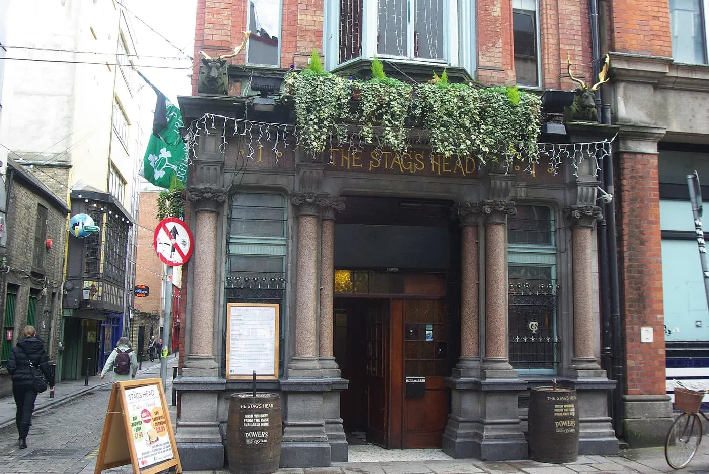 The granite and red-brick front of the Stag's Head on Dame Court, with hanging baskets above the entrance