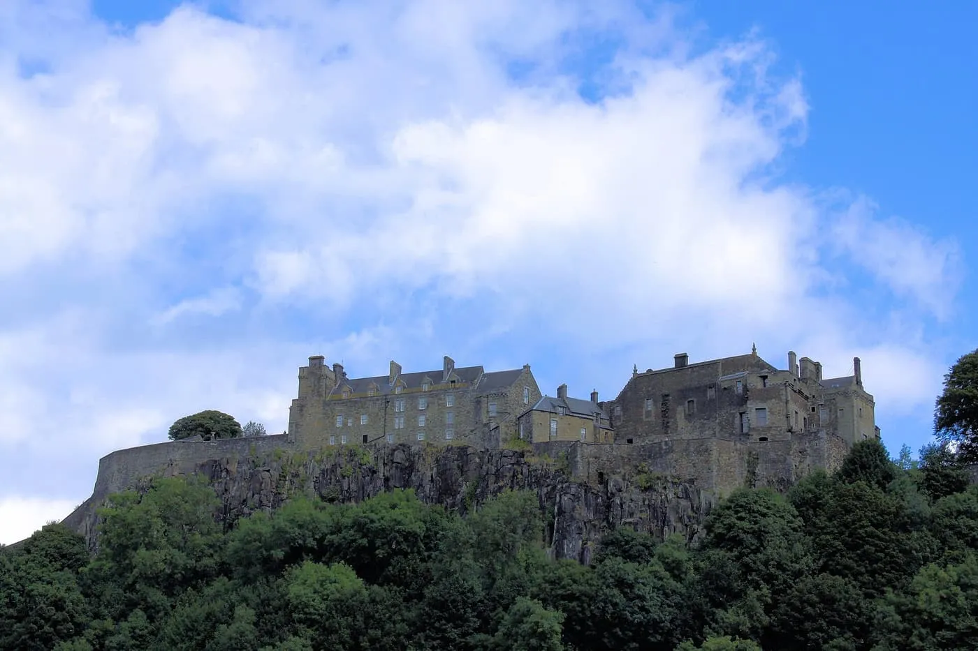 Stirling Castle on its rock above the trees, seen from below