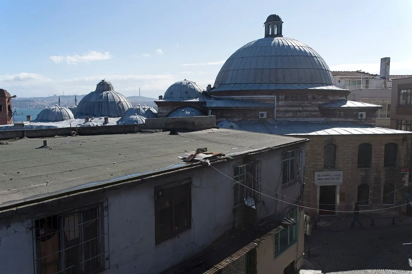The lead-covered domes of the Süleymaniye hammam rising above the rooftops beside the mosque complex