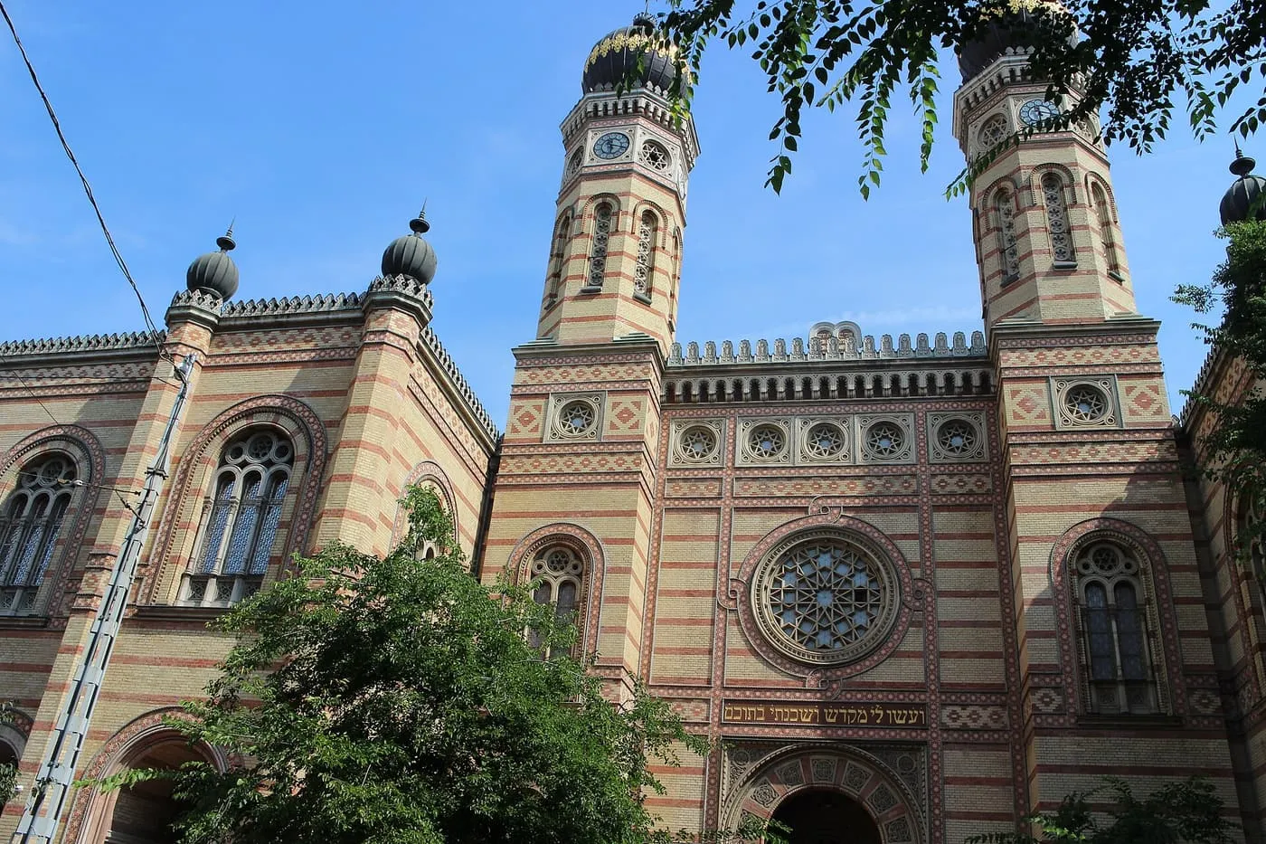 The brick-striped Moorish front of the Dohány Street Synagogue, with its two onion-domed towers and a rose window