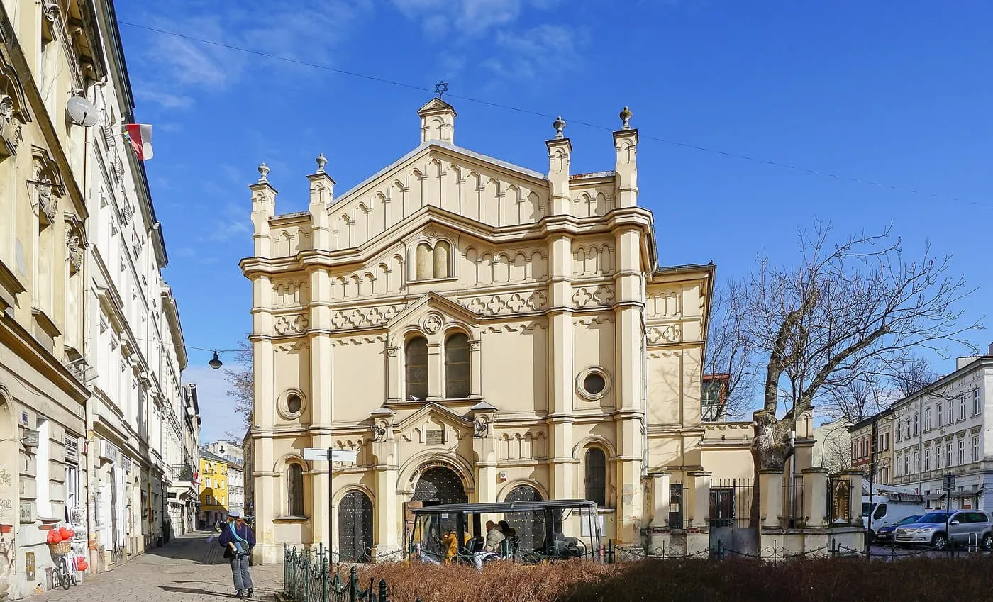 The cream-coloured front of the Tempel Synagogue on Miodowa Street, with pinnacles, arched windows and Moorish ornament under a blue sky