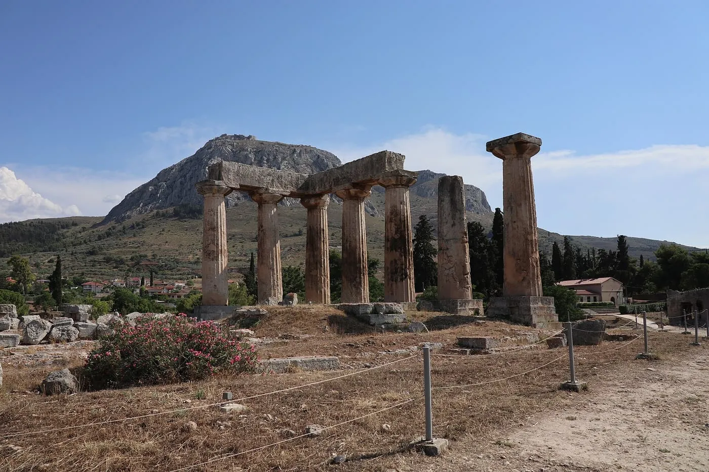 Seven columns of the Doric Temple of Apollo at Ancient Corinth, with the rock of Acrocorinth rising behind them