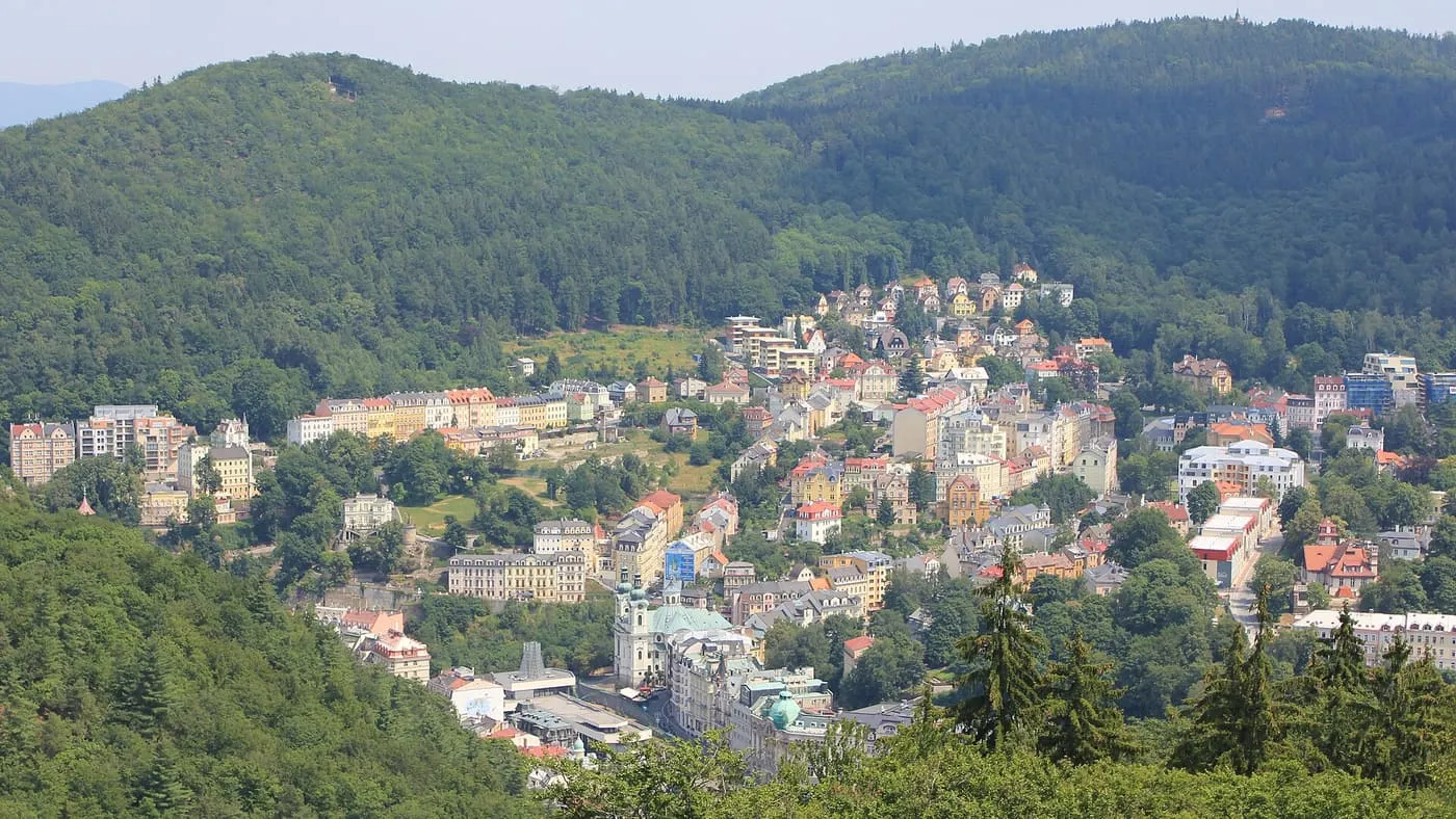 Looking down over the red-roofed spa town of Karlovy Vary, in its wooded valley, from the Diana tower