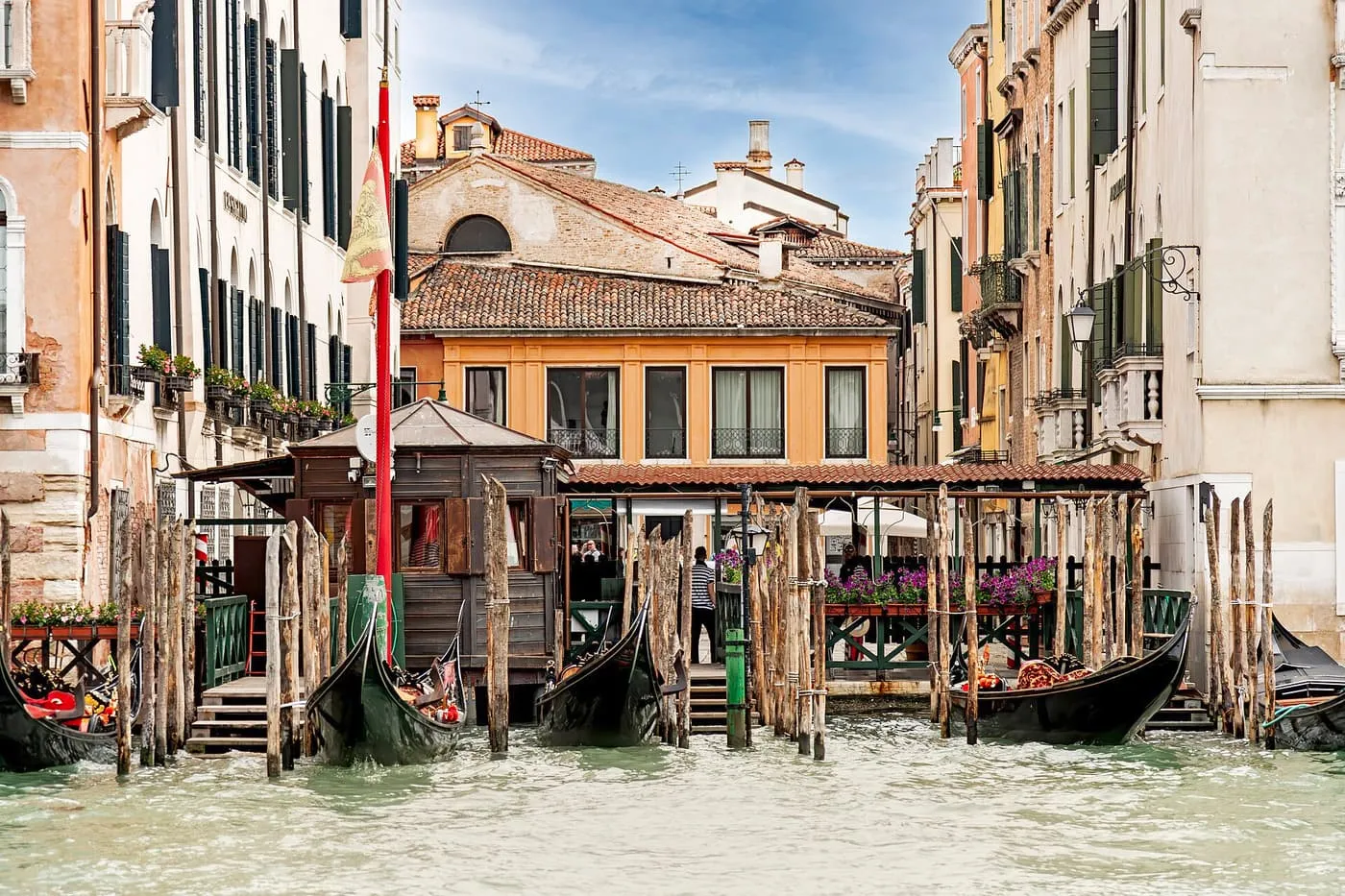 A wooden landing stage on the Grand Canal with gondolas tied up at the Santa Sofia traghetto