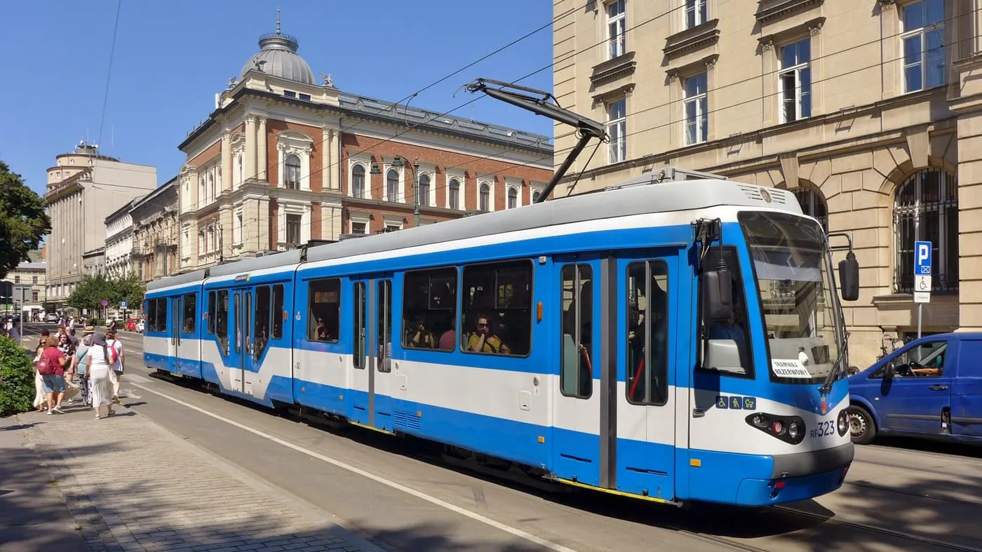 A blue and white tram on ul. Basztowa, with period buildings behind