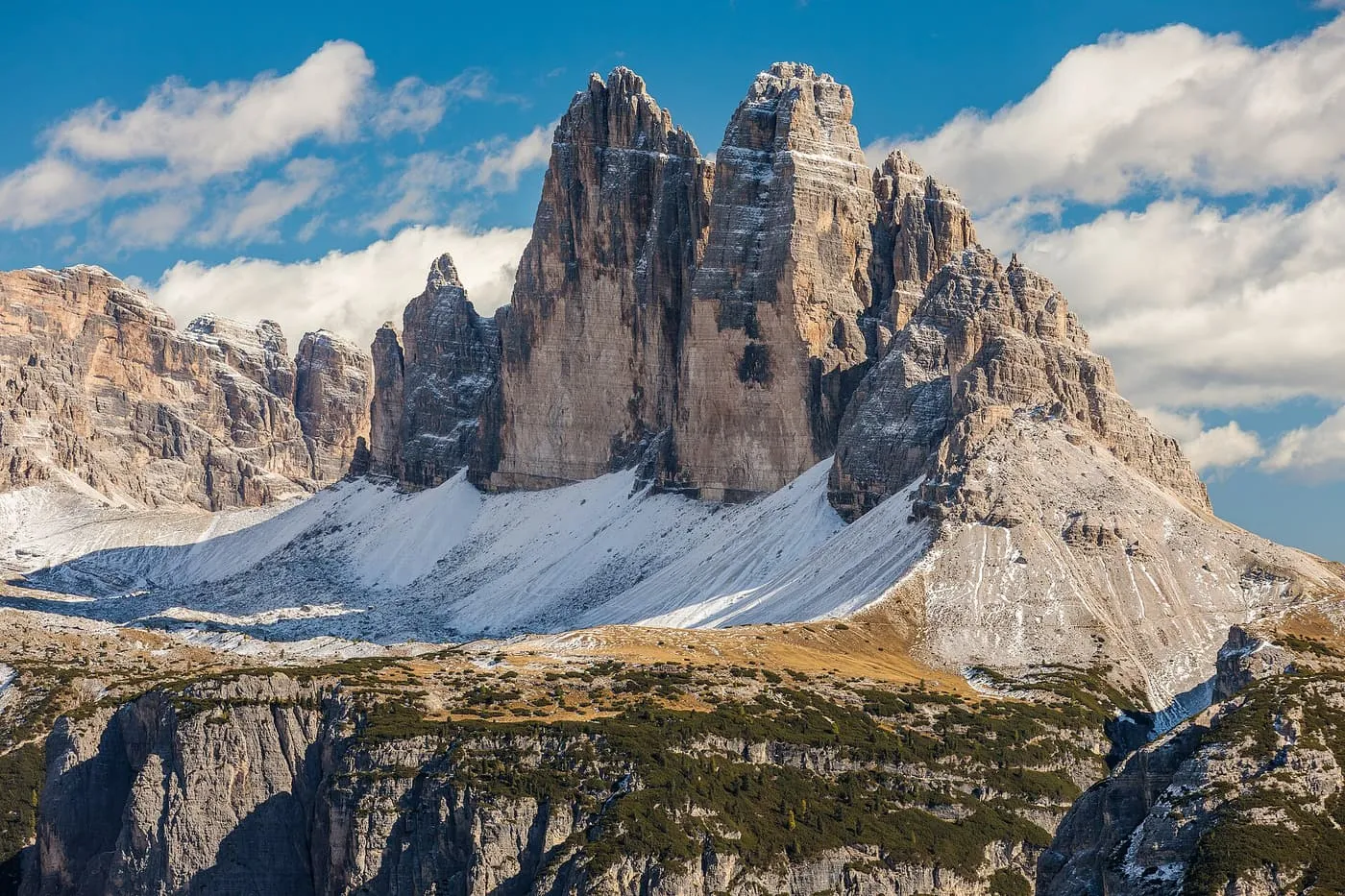 The three sheer limestone towers of the Tre Cime di Lavaredo above a slope dusted with snow