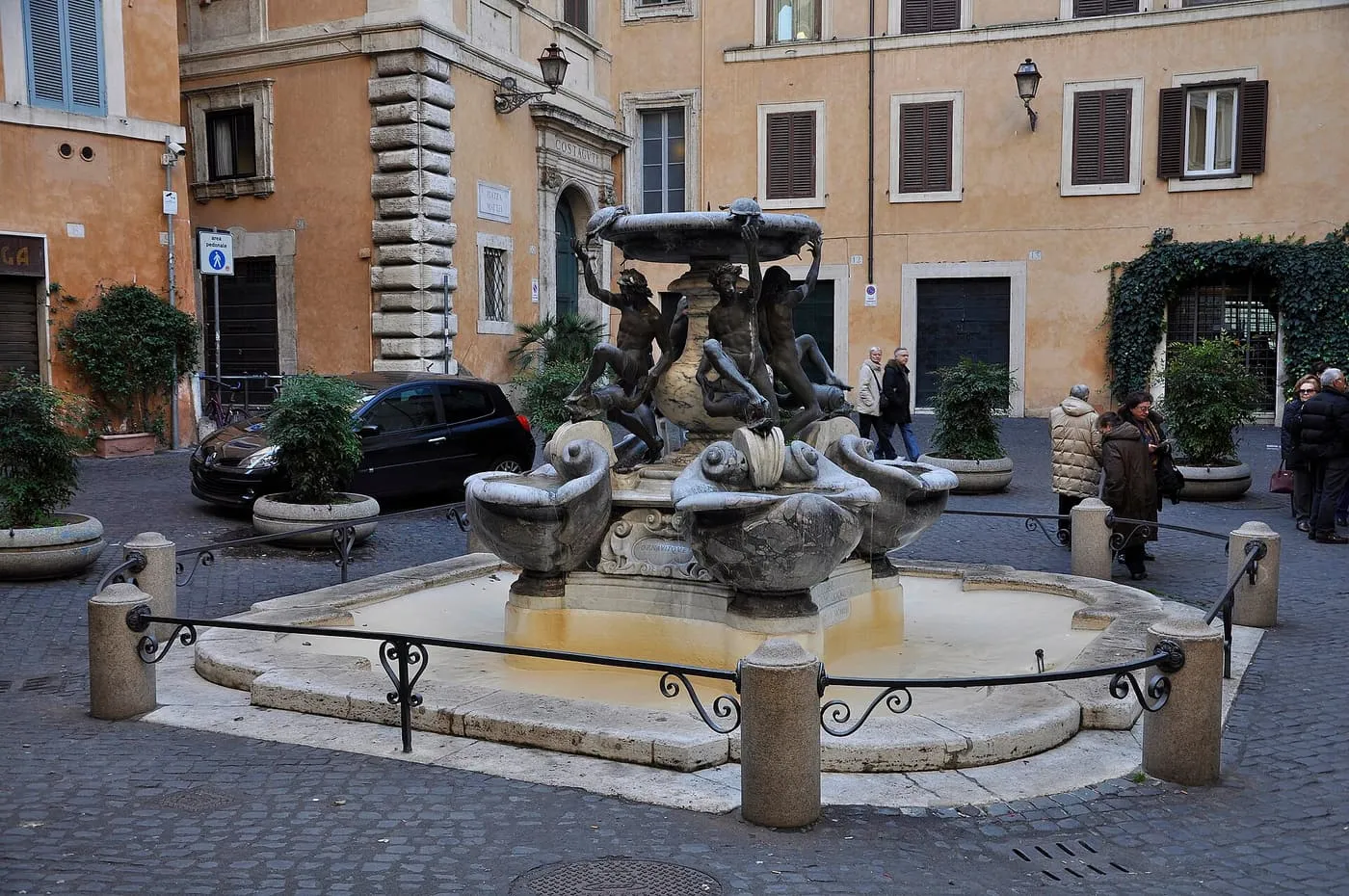 The Turtle Fountain on the cobbles of Piazza Mattei, four bronze youths holding turtles up to the top basin, with ochre palazzi behind
