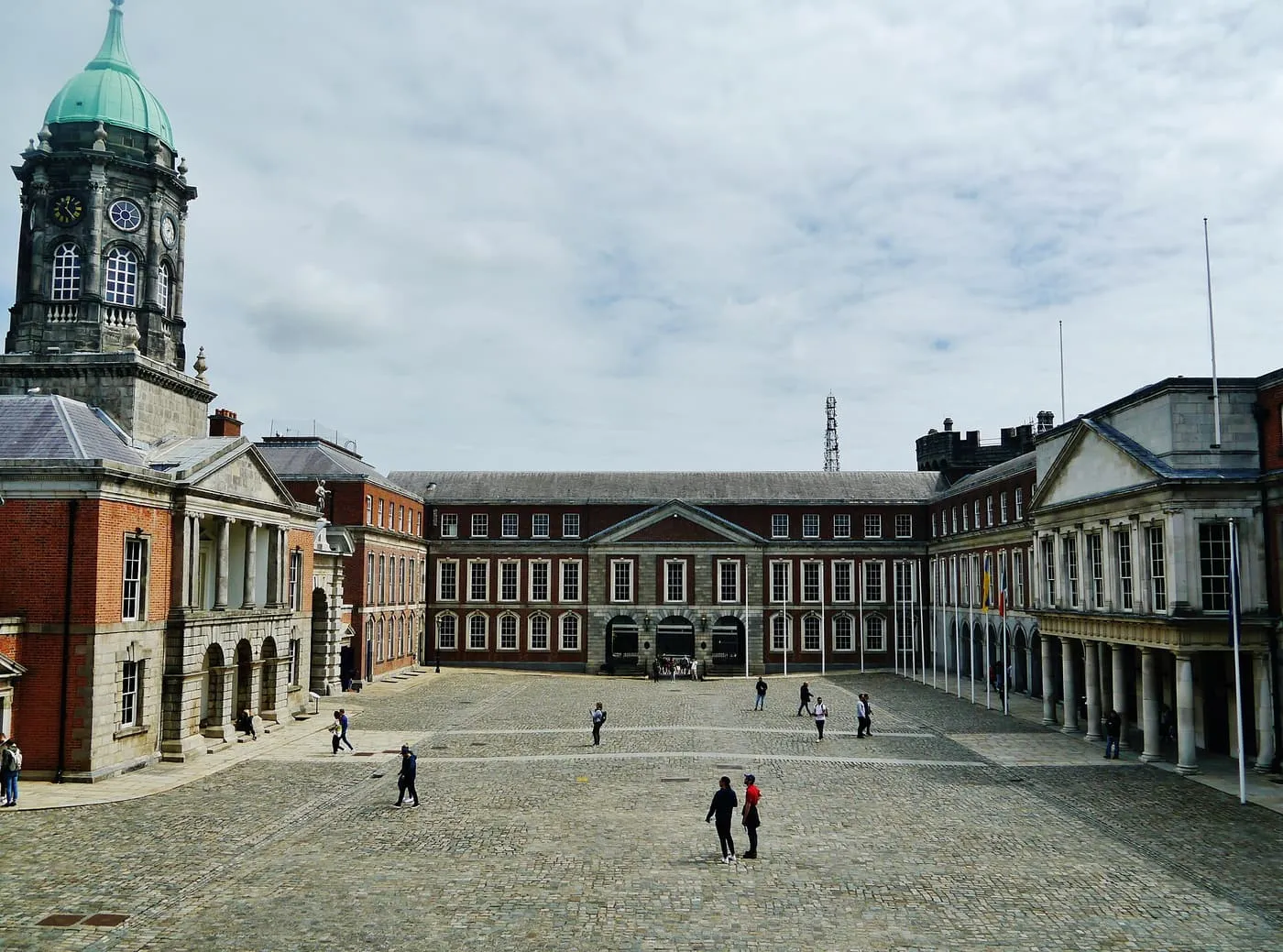 The cobbled Upper Yard at Dublin Castle, with the green-domed Bedford Tower on the left and long red-brick and stone ranges around the yard