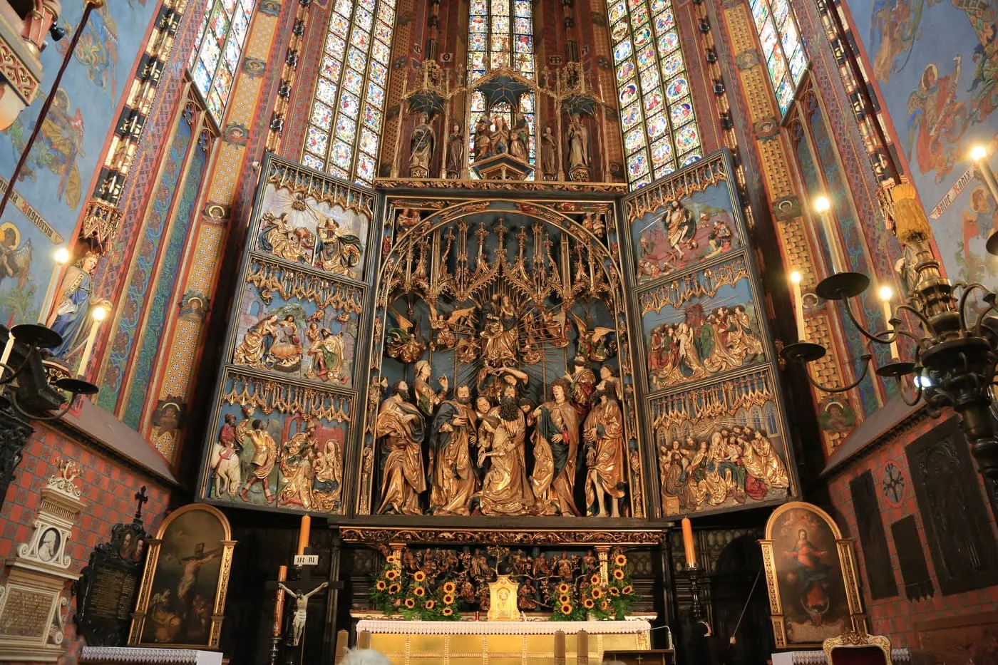 The open Veit Stoss altarpiece in St Mary's Basilica, with gilded figures of the apostles under a Gothic canopy and stained glass above