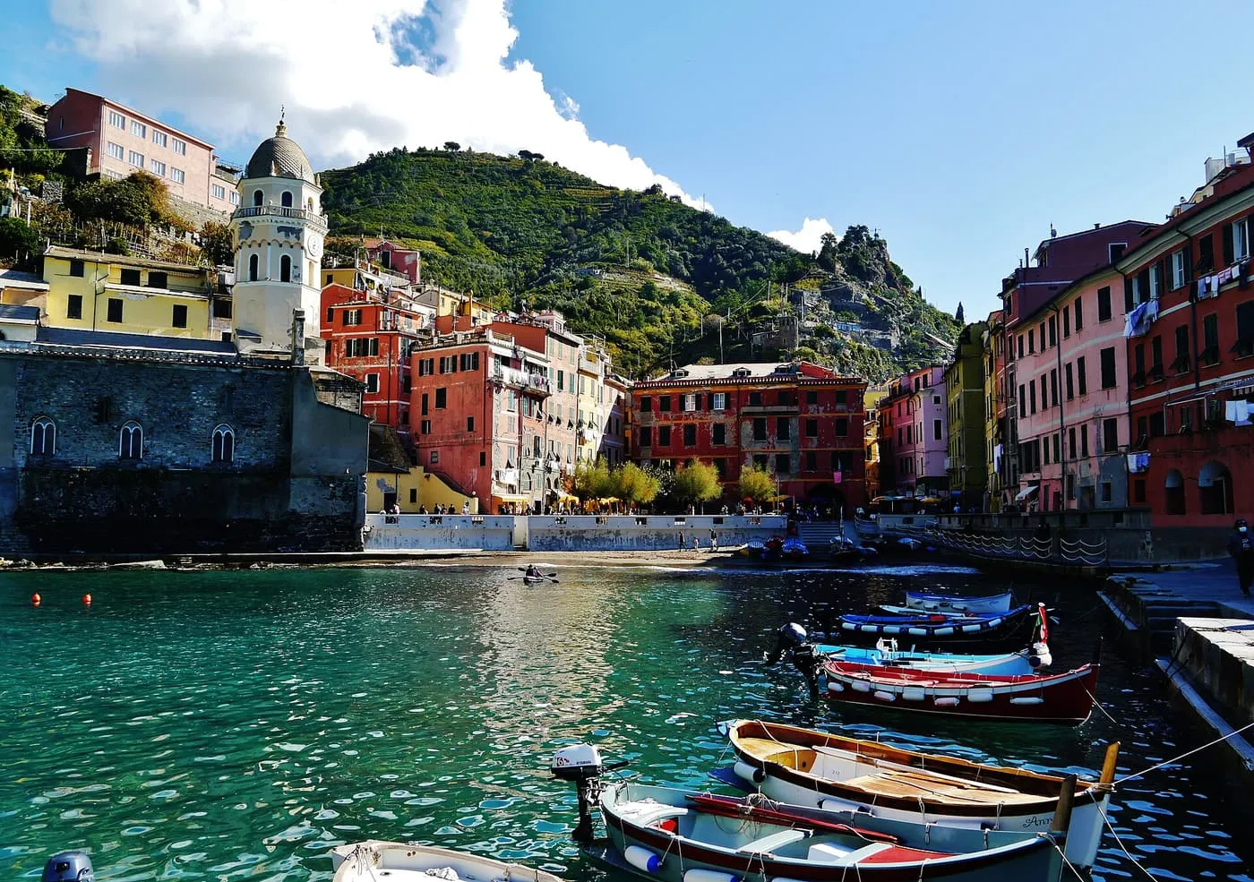 Fishing boats in the small harbour of Vernazza, with the church tower and coloured houses behind
