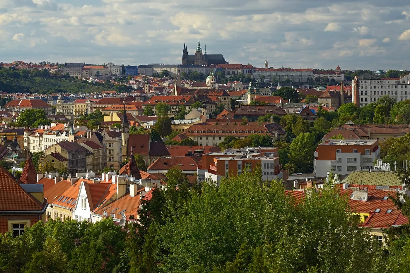 Red roofs of Prague with St Vitus Cathedral and the Castle on the skyline, seen from Vyšehrad