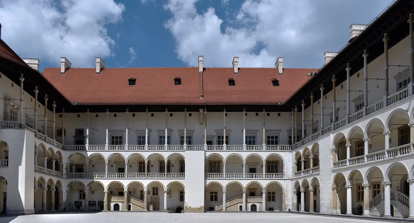 The Arcaded Courtyard of Wawel Castle, three storeys of white arcades under a red tiled roof round a paved square
